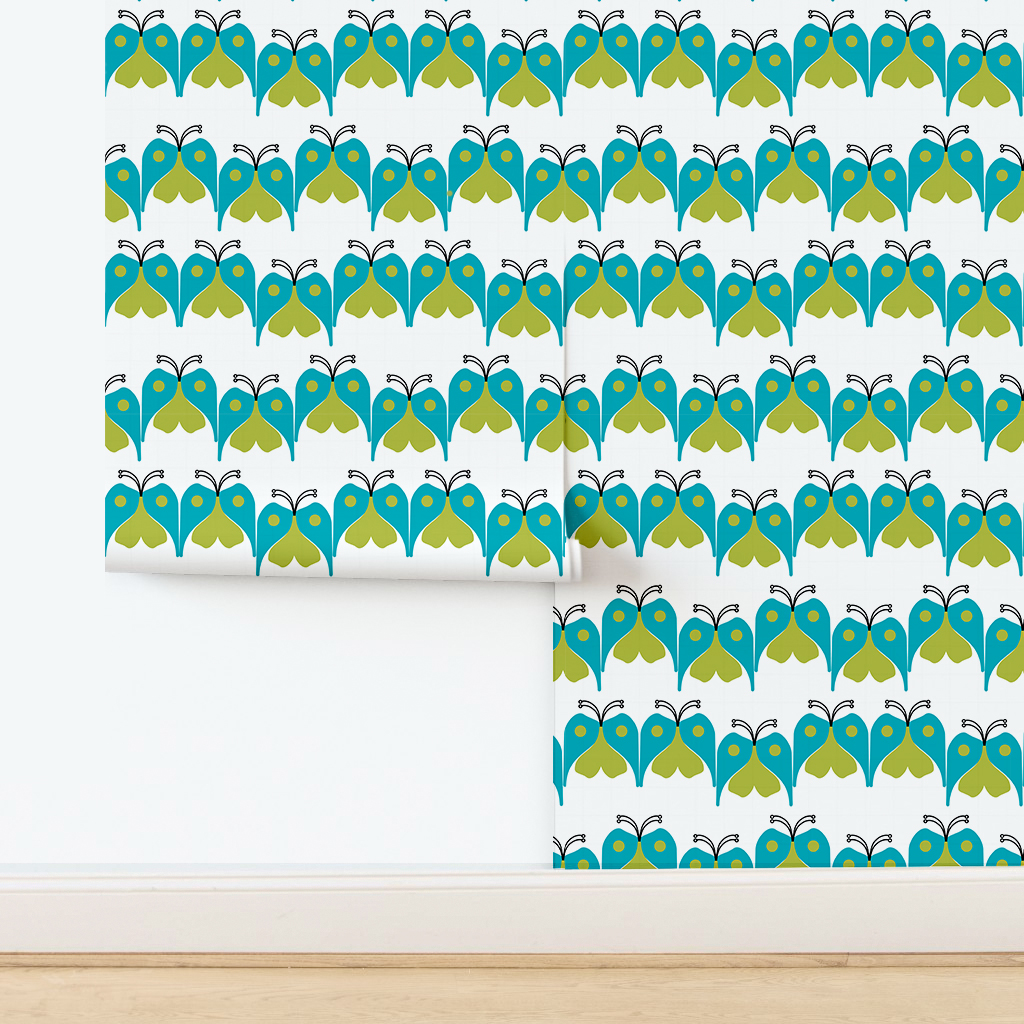 The artwork features a repeating geometric pattern of symmetrical shapes resembling elongated, curved diamonds or petals in various shades of blue and green. Each shape is split vertically with one half filled with a light blue and the other half filled with green or darker blue. The background is a light, almost pastel blue, which provides a soft yet vibrant backdrop. One of the blue shapes near the upper left contains a white starburst element, adding a focal point of brightness to the composition. The overall design conveys a modern, mid-century aesthetic with clean lines and harmonious color contrasts.